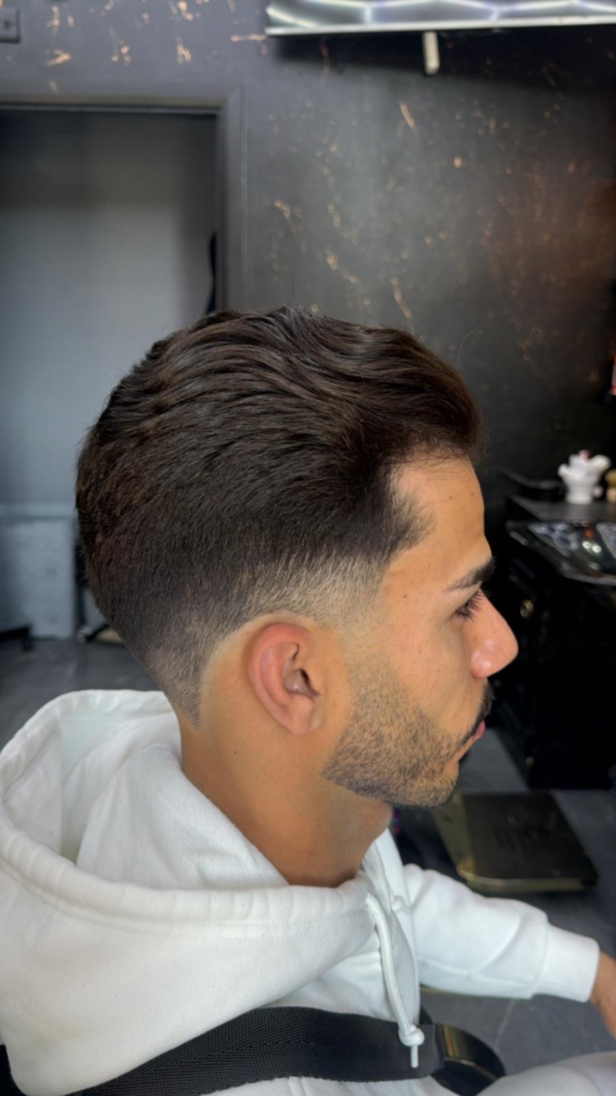 Classic side sweep with skin fade and sculpted beard line