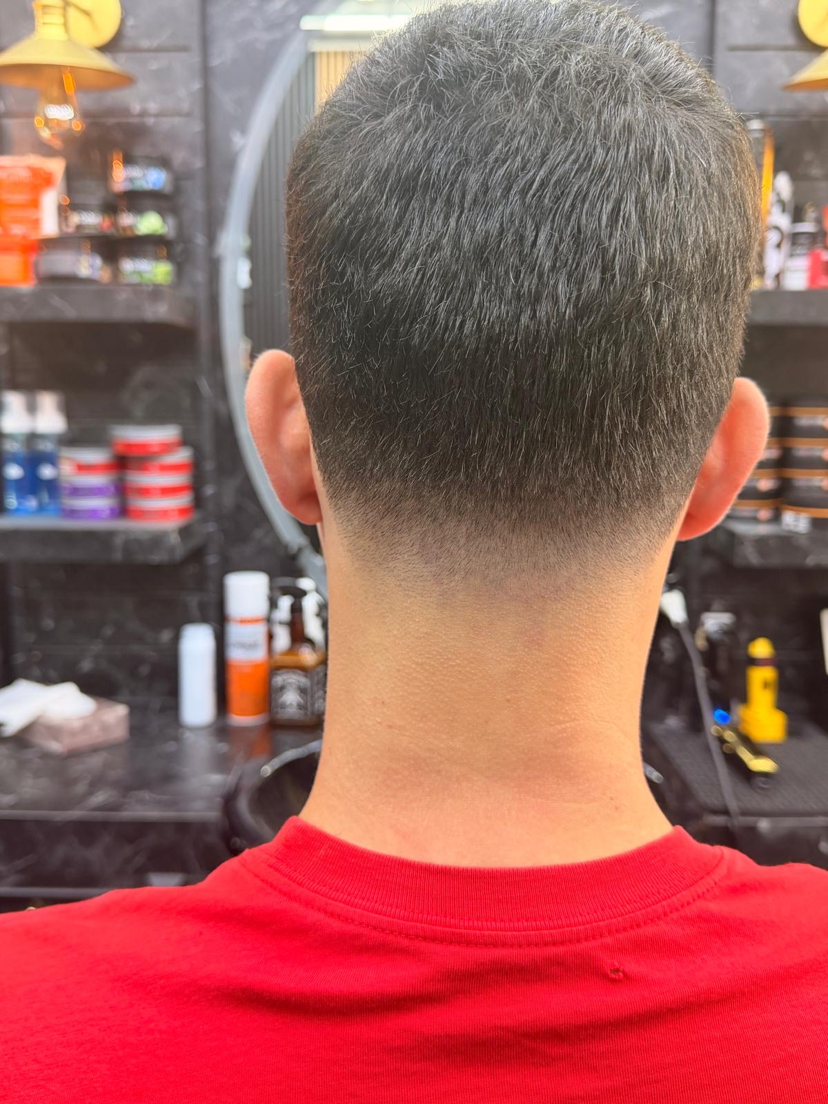 Back view of a symmetrical taper fade and clean neckline at Xalo Barbers in Cricklewood