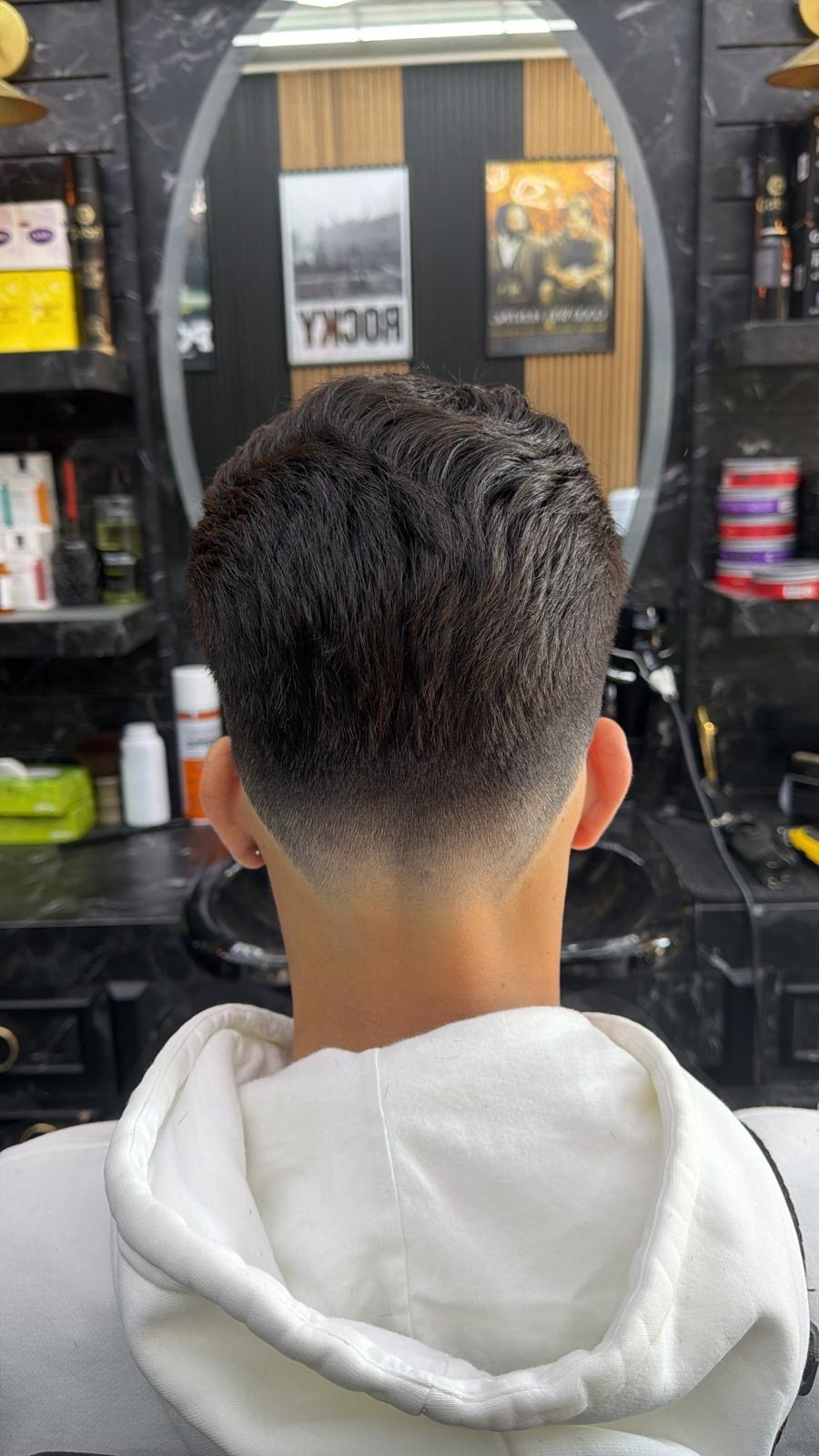 Back view of a clean low taper fade haircut at Xalo Barbers in Cricklewood